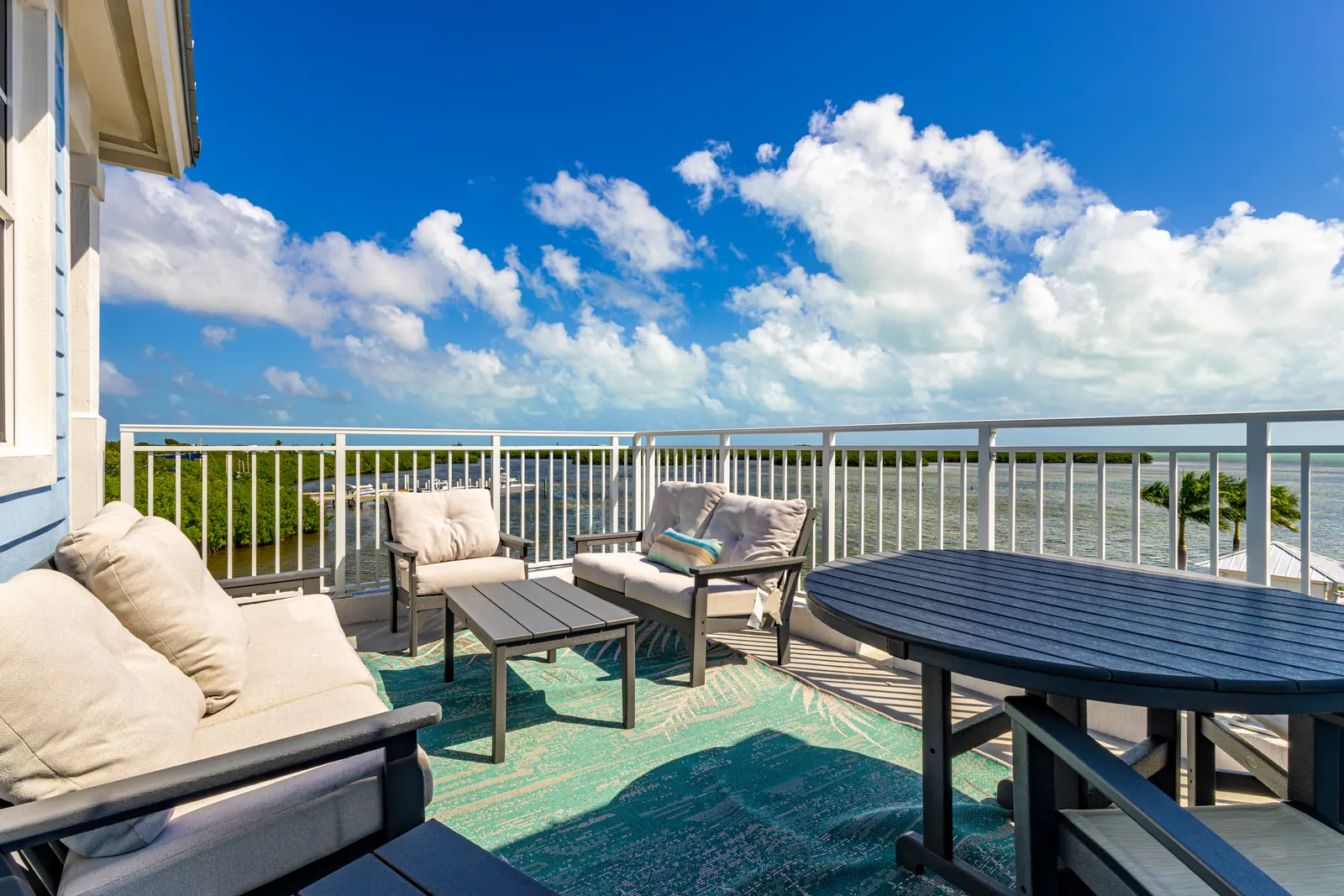 Furnished balcony at Playa Largo Ocean Residences overlooking the water in the Florida Keys.